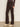 A person models Sanctuary Clothing's corduroy hayden bootcut pant in semi sweet, paired with beige ankle boots, standing against a neutral background with only their lower body visible.