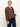 Someone wears the Sanctuary Clothing personal best blouse boheme—a loose, long-sleeve brown top with a white floral pattern—paired with dark blue jeans, standing against a plain light background.