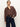 A woman models the Sanctuary Clothing personal best blouse boheme, paired with dark blue high-waisted jeans and a brown belt, against a plain light background.