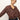 A woman with blonde hair tied back wears the Sanctuary Clothing personal best blouse boheme, featuring a white floral pattern, paired with dark jeans and a brown belt. She looks toward the camera with a neutral expression.