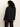 A person with curly hair, facing away from the camera against a plain light background, wears the Sanctuary Clothing new era tuxedo shirt in black.