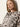 A woman with long straight hair confidently models the Sanctuary Clothing wild dreamer blouse mother leo, featuring a bold black animal print on a light background.