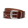 The Rowan Studded Belt Mahogany by Sanctuary Clothing features silver studs in different sizes and a shiny silver buckle, shown coiled on a white background.