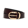 The Sanctuary Clothing All Day Belt in Dark Crimson features a shiny gold buckle and is coiled neatly against a white background.