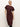 A woman with blonde hair models the Sanctuary Clothing cinched waist t shirt dress in chicory, featuring short sleeves and a midi length, standing against a plain light background with one hand on her hip.