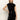 A woman poses against a plain light background in the Sanctuary Clothing "an affair to remember dress black," a sleeveless, high-neck sequin mini dress, with one hand on her hip.
