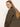 A woman with long straight blonde hair wears the Sanctuary Clothing barn jacket in burnt olive, looking over her shoulder at the camera against a plain light background.