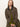 A woman with straight, light brown hair models the Sanctuary Clothing barn jacket in burnt olive over green separates, sitting against a plain background and looking directly at the camera with a neutral expression.
