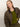 A woman with straight blonde hair wears the Sanctuary Clothing barn jacket in burnt olive. She gazes right with a neutral expression against a plain, light background.