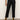 A person in Sanctuary Clothing's the marine jeans after hours—high-waisted black jeans with frayed hems—paired with a white top and tan suede ankle boots, stands against a light-colored wall.