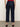 A person wearing Sanctuary Clothing's cadence 90s straight crop plot twist jeans, shown from the back with raw hems and black shoes against a plain light background.