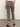 Someone stands indoors facing away, wearing Sanctuary Clothing's cadence 90 straight crop jeans in French Kitty—a high-waisted, cropped leopard-print style—paired with black ankle-strap heels against a neutral wall and floor.