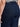 A close-up of a person wearing Sanctuary Clothing's league crop plot twist extended sizing denim jeans, highlighting the back pocket and waistband details with a black-and-white striped top.