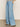 Person wearing Sanctuary Clothing's Highland Wide Leg Standard Rise Jeans in Sail Away, styled with black sandals and a striped top, photographed against a plain light background.