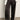 Someone wears the Sanctuary Clothing satin track pant in black, featuring white side panels, paired with a white button-down shirt and black pointed-toe shoes, standing on a gray floor against a plain wall.