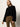 A woman wears Sanctuary Clothing's Fairway Legging in Dirty Martini, posing confidently against a neutral background.