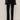 Wearing Sanctuary Clothing's velveteen brook bootcut pant in black with a black, flared-cuff long-sleeve top and black ankle boots, the person stands against a plain light wall, shown from shoulders to feet.
