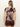 A woman with straight, light brown hair faces away, wearing Sanctuary Clothing's "the perfect tee mesa palm," a short-sleeve maroon and beige palm leaf print shirt, and matching maroon shorts against a plain light background.