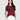 A woman with long dark hair models the Sanctuary Clothing perfect tee remix night berry, a maroon short-sleeve t-shirt, paired with white high-waisted pants against a plain light gray background, one hand in her pocket.