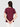 A person with straight brown hair stands with their back to the camera, wearing Sanctuary Clothing's perfect tee remix night berry and white pants, hands clasped behind them.