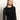 A person with long, straight blond hair wears the Sanctuary Clothing long sleeveperfect mesh tee in black, styled with blue jeans and a black belt, standing against a neutral background.