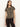 A woman with long brown hair wears the Sanctuary Clothing double knit perfect tee in winter leopard and dark pants, standing against an off-white background. She looks to the side with a neutral expression.