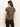 A woman with long brown hair, seen from behind, wears the Sanctuary Clothing double knit perfect tee winter leopard—a short-sleeved brown leopard print top—paired with dark pants against a plain light background.