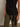 Model wears the Sanctuary Clothing side tie muscle tee in black, paired with olive green pants against a neutral background. Only the torso and upper legs are shown.