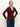 A woman wears the Sanctuary Clothing long sleeve textured top in chicory with jeans, standing against a plain light background, gazing slightly upward and resting her hands on her hips.