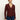 A woman stands against a plain light background, wearing the Sanctuary Clothing long sleeve textured top in chicory and blue jeans. She looks relaxed, with her left hand by her side and her right hand slightly forward.