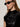 A woman looks to the side against a plain light background, wearing black oval sunglasses, gold hoop earrings, and a Sanctuary Clothing funnel neck sequin top in black.