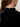 Close-up of a person’s upper back in the Sanctuary Clothing funnel neck sequin top in black, featuring a small back zipper. The person has long brown hair and wears a gold hoop earring.