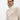 A dark-haired person wears the Sanctuary Clothing's "open knit 1/2 zip sweater eco natural," a light beige knitted sweater with a zipper, against a white background. The sweater features a textured, open-knit design as they face the camera.