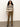 A woman with curly hair wears the Sanctuary Clothing fairisle crew neck sweater in light oat multi, paired with brown corduroy pants and black boots, standing against a plain light-colored wall.