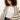 A woman with curly hair wears the Sanctuary Clothing openwork beach cardi in chalk black stripe over a white t-shirt and denim jeans, standing against a plain light background.