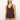 A woman with straight, light brown hair models the Sanctuary Clothing v neck knitwear tank mesa in dark brown, paired with light green pants. She stands against a plain background, gazing slightly to the side with a neutral expression.
