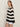 A woman with straight brown hair and hoop earrings stands sideways against a light background, wearing Sanctuary Clothing's textured raglan crew chalk black stripe sweater (size 6) and white shorts.
