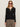 A woman in red sunglasses and leopard print pants models the Sanctuary Clothing lightweight ribbed cardi in black, standing against a plain light background.