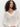 A woman with curly dark hair models the Sanctuary Clothing airy openwork sweater macrame, a cream-colored long-sleeve crochet knit V-neck, against a plain white background.