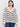 A woman with straight dark hair wears the Sanctuary Clothing airy openwork sweater in chalk black stripe (extended sizing), styled with blue jeans, standing against a plain light background.