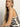 A woman with long blonde hair models the Sanctuary Clothing city summer tank black macrame stripe 2, a sleeveless, black-and-white striped top with side buttons. She gazes confidently at the camera against a plain light background.