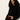 A woman with long curly hair wears the Sanctuary Clothing forever cashmere popover in black, pairing it with dark burgundy pants as she stands confidently against a light-colored wall.