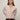 A woman with straight, light brown hair models the Sanctuary Clothing "must have cardi" in heather rose, styled with dark pants and a brown belt, standing against a plain light background with her hands behind her back.