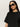 Woman with long dark hair wears black sunglasses, gold hoop earrings, and the Sanctuary Clothing perfect sweater tee in black, standing against a plain light background.