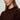 A woman with light brown hair and silver hoop earrings stands with her arms crossed, wearing the Sanctuary Clothing perfect sweater tee in dark crimson, gazing slightly to the side with a neutral expression.
