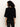 A woman with curly hair faces away from the camera, wearing the Sanctuary Clothing ribbed sweater tee in black against a plain light background.