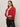 A woman with straight, light brown hair wears the Sanctuary Clothing ribbed sweater tee in cherry lacquer, styled with black leather pants, a leopard print belt, and gold jewelry against a plain light backdrop.