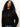 Wearing the Sanctuary Clothing boheme popover black sweater, a person with long curly hair and blue jeans stands against a plain light background, calmly looking at the camera.