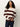 A person with long curly hair wears the Sanctuary Clothing 24 7 popover chicory light oat sweater, featuring wide maroon stripes, paired with dark jeans against a plain light background.