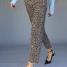 A person wearing Sanctuary Clothing cadence 90 straight crop jeans in french kitty leopard print, paired with a light blue sweater and black pointed-toe heels, walks against a plain background. Only the lower half is visible.